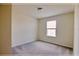 Cozy bedroom with a plush carpet and a window, providing a peaceful space at 16129 Palm Frond Ave, Clermont, FL 34714