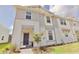 Stylish townhome showcasing a two-story facade, manicured lawn, and welcoming front entrance at 16129 Palm Frond Ave, Clermont, FL 34714