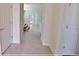 Hallway with ceramic tile floors, white doors, and stairs leading to the second floor at 16129 Palm Frond Ave, Clermont, FL 34714