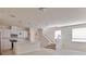 Open floor plan featuring a modern kitchen with white cabinetry and a center island at 16129 Palm Frond Ave, Clermont, FL 34714