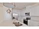 Modern kitchen with stainless steel appliances, white cabinets and granite countertops at 16129 Palm Frond Ave, Clermont, FL 34714