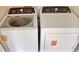 Laundry area featuring a white washer and dryer at 16129 Palm Frond Ave, Clermont, FL 34714