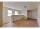 Bright loft area with hardwood floors, offering two windows for natural light, and multiple closet doors at 16129 Palm Frond Ave, Clermont, FL 34714