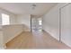 Open loft area with bright hardwood flooring, offering ample space with multiple windows and closet for storage at 16129 Palm Frond Ave, Clermont, FL 34714