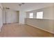 Spacious loft featuring hardwood floors, two windows for natural light, and multiple doors for easy access at 16129 Palm Frond Ave, Clermont, FL 34714