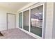 Covered patio with sliding glass doors that lead to the indoor living space and pool area at 16129 Palm Frond Ave, Clermont, FL 34714