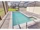 Sparkling screened-in pool surrounded by brick pavers, ideal for outdoor relaxation and entertainment at 16129 Palm Frond Ave, Clermont, FL 34714