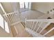 Bright foyer with wooden stairs and white railing leading to an open-concept living area with tile flooring and natural light at 16129 Palm Frond Ave, Clermont, FL 34714