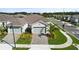 Aerial view of a well-maintained home with a landscaped front yard and an attached two-car garage at 1650 Key Bay Trl, Kissimmee, FL 34747