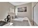 Comfortable bedroom featuring a cozy bed, modern artwork, and ample natural light at 1650 Key Bay Trl, Kissimmee, FL 34747