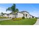 Inviting single-story home with a well-maintained lawn, paved driveway, and tropical palm trees at 1650 Key Bay Trl, Kissimmee, FL 34747