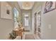 Bright foyer featuring a decorative light fixture, stylish console table, and tiled flooring at 1650 Key Bay Trl, Kissimmee, FL 34747