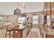 Bright kitchen showcasing granite countertops, stainless steel appliances, and a large island with seating at 1650 Key Bay Trl, Kissimmee, FL 34747