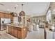 Open-concept kitchen featuring stainless steel appliances, large island, pendant lights, and a seamless connection to living spaces at 1650 Key Bay Trl, Kissimmee, FL 34747