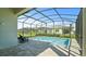 Relax by the screened-in pool in this serene backyard oasis, complete with comfortable lounge chairs at 1650 Key Bay Trl, Kissimmee, FL 34747