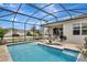 Screened-in pool and spa area with outdoor seating, perfect for relaxation and entertainment at 1650 Key Bay Trl, Kissimmee, FL 34747