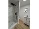 Modern bathroom featuring marbled shower, black fixtures, and updated vanity at 2035 Voltaire St, Lakeland, FL 33801