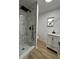 Modern bathroom featuring marbled shower, black fixtures, and updated vanity at 2035 Voltaire St, Lakeland, FL 33801