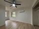 Bright bedroom featuring wood-look floors, natural light, and a ceiling fan at 2035 Voltaire St, Lakeland, FL 33801