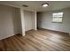 Bedroom with wood-look flooring, closet, and a window bringing in natural light at 2035 Voltaire St, Lakeland, FL 33801