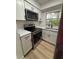 Updated kitchen features stainless steel appliances, white cabinets, and modern countertops at 2035 Voltaire St, Lakeland, FL 33801