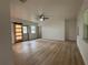 Living room with updated floors, a barn door, neutral paint, and ample natural light at 2035 Voltaire St, Lakeland, FL 33801