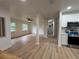 Bright living area leads to a modern kitchen, featuring new floors, fresh paint, and abundant natural light at 2035 Voltaire St, Lakeland, FL 33801