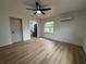 Spacious living room with wood flooring, ceiling fan, and ample natural light at 2035 Voltaire St, Lakeland, FL 33801