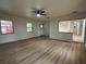 Spacious living room with wood-look flooring, and natural light, showcasing seamless transitions to other rooms at 2035 Voltaire St, Lakeland, FL 33801