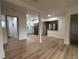 Spacious living room boasts modern flooring and fresh, bright paint, with an open view of the updated kitchen at 2035 Voltaire St, Lakeland, FL 33801