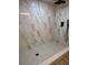Modern shower featuring stylish tile, a rainfall shower head, and contemporary fixtures at 2035 Voltaire St, Lakeland, FL 33801