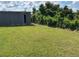 Expansive backyard with lush green grass, mature trees, and a storage shed providing ample space for outdoor enjoyment at 2085 San Jose Blvd, Orlando, FL 32808