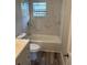 This updated bathroom features marble tile accents, modern fixtures, and sleek vanity at 2085 San Jose Blvd, Orlando, FL 32808