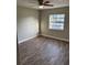 An inviting bedroom featuring stylish flooring, a ceiling fan, and natural light from the window at 2085 San Jose Blvd, Orlando, FL 32808