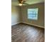 A comfy bedroom has stylish flooring, ceiling fan, and lots of natural light at 2085 San Jose Blvd, Orlando, FL 32808