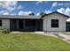 Charming single-story home with a screened porch, freshly painted exterior, and well-maintained lawn at 2085 San Jose Blvd, Orlando, FL 32808