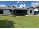 Charming single-story home with a screened porch, freshly painted exterior, and well-maintained lawn at 2085 San Jose Blvd, Orlando, FL 32808
