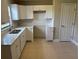 Updated kitchen features new white cabinets, stainless steel sink, quartz countertops, and tiled backsplash at 2085 San Jose Blvd, Orlando, FL 32808