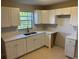 The kitchen is updated with modern cabinets, stainless steel appliances, and tile flooring at 2085 San Jose Blvd, Orlando, FL 32808