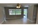 Spacious living room featuring tile floors, a ceiling fan, neutral wall color, and a view of the yard at 2085 San Jose Blvd, Orlando, FL 32808