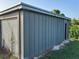 View of the exterior of the metal shed with a roll-up door and an entry, great for extra storage and organization at 2085 San Jose Blvd, Orlando, FL 32808