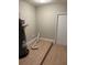 Utility room with wood look flooring, water heater, hook ups for laundry, and a white door at 2085 San Jose Blvd, Orlando, FL 32808