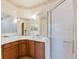 Elegant bathroom features a mirrored vanity, spacious walk-in shower, and modern fixtures at 223 Monterey St, Kissimmee, FL 34759