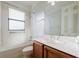 Well-lit bathroom with a combined tub and shower, vanity, and large mirror at 223 Monterey St, Kissimmee, FL 34759