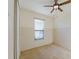 Bright bedroom features a ceiling fan, a large window, and a spacious closet at 223 Monterey St, Kissimmee, FL 34759