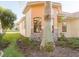 Close-up exterior of a home with stone accents, an arched window, a tile roof and landscaping at 223 Monterey St, Kissimmee, FL 34759