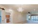 Bright living room features modern chandelier and glass sliding doors, providing plenty of natural light at 223 Monterey St, Kissimmee, FL 34759