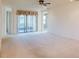 Bright living room with neutral carpet and patio doors at 223 Monterey St, Kissimmee, FL 34759
