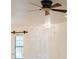 Inviting living room with modern ceiling fan and large window offering ample natural light at 223 Monterey St, Kissimmee, FL 34759