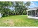 Lush backyard with green grass and a screened in patio at 229 Marcum Trace Dr, Lakeland, FL 33809